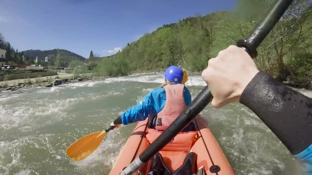 Two people on rafting on mountain river at spring time. Extreme professional water sport

