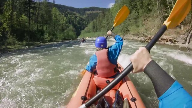 Two people on rafting on mountain river at spring time. Extreme professional water sport

