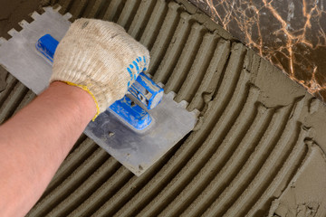 Close-up of a master's hand that makes furrows in a glutinous solution