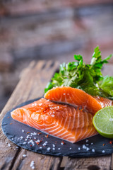 Raw salmon fillets with parsley herbs lime lemon salt and dried saffron