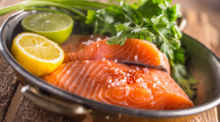 Raw salmon fillets with parsley herbs lime lemon salt and dried saffron