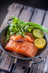 Raw salmon fillets with parsley herbs lime lemon salt and dried saffron