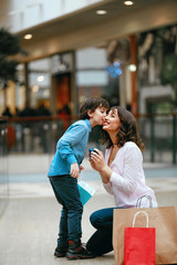 Fototapeta premium Shopping Centre. Child Giving Presents To Mother