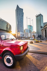 Modern skyscrapers at Warsaw down town, Poland with old vintage cars