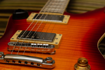 Electric guitar body and neck detail on wooden background vintage look