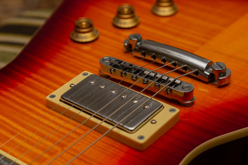 Electric guitar body and neck detail on wooden background vintage look