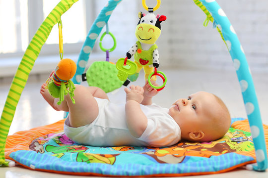 Baby on the play Mat. The concept of development of the newborn.
