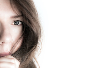 young woman half-face, eye, looking in lens, copy space
