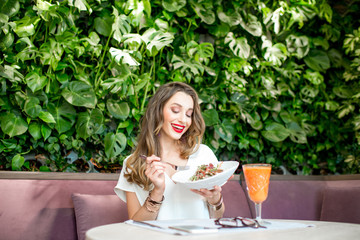 Woman eating salad at the vegetarian restaurant