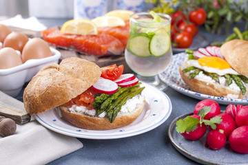 Fresh bread for breakfast, with egg, salad, asparagus, salmon, radish. Healthy food. Place for text.