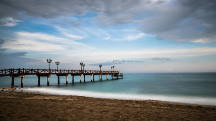 Obraz premium Beach in Marbella at Sunset on a cloudy day