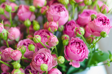 wedding bouquet of roses and pions of berries and greens with lavender.