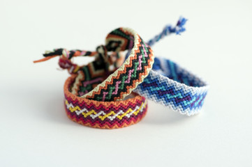 Group of handmade homemade natural woven bracelets of friendship isolated on white background