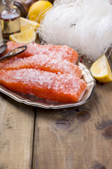Asian food. Rice noodles and salmon, lemon and spices. Dietary food. Healthy food. Wooden background. Place for text.