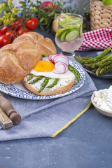 Fresh bread for breakfast, with egg, salad, asparagus, salmon, radish. Healthy food and drink. Place for text.