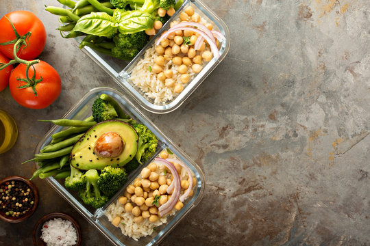 Vegan meal prep containers with cooked rice and chickpeas