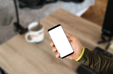 Man holding modern smartphone with isolated white screen for mock up presentation
