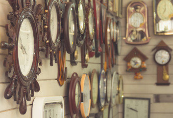 Clocks hanging on wall at shop. Time concept