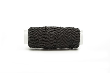 Black elastic thread on the coil horizontally isolated on white background