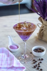Ice purple potato with cold coffee on table