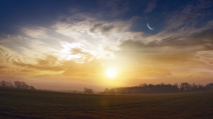 Naklejka na ściany i meble new moon . Prayer time . Generous Ramadan . Mubarak background . Glowing sunset . Glowing sunset . Sunset or sunrise with clouds . Dramatic nature background 