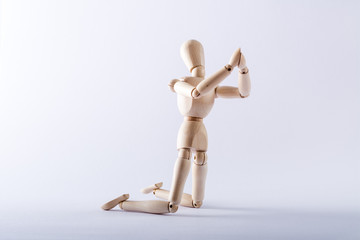 wooden doll in imploration position
