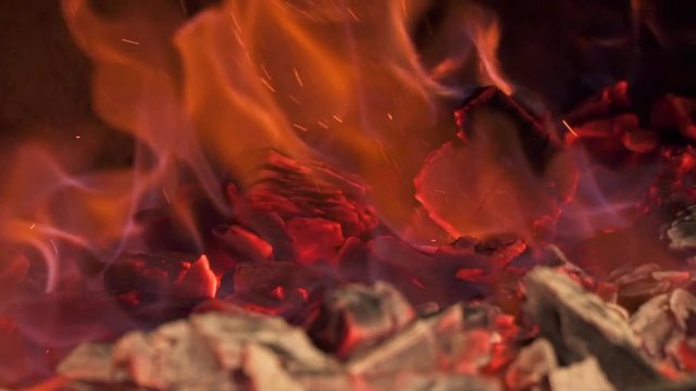 Close-up of burning coals in the stove. Slow motion.