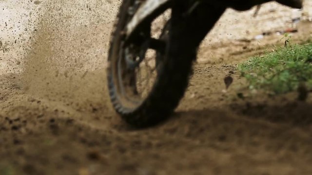 Shot of the Professional Motocross Driver Riding on His FMX Motorcycle on the Extreme Off-Road Track 4k