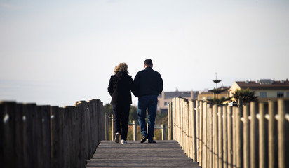 Middle-Aged Couple Walks on Walkway