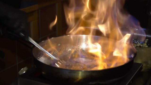 Professional Chef Cooks Flambe Style.