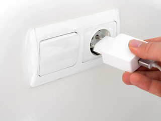 Fototapeta premium phone charger on the wall at home