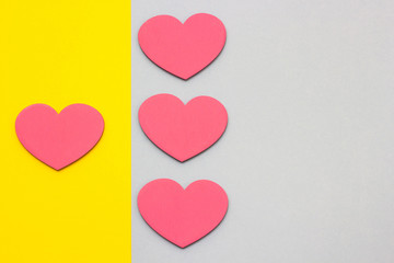 Wooden hearts on a multi-colored background, top view