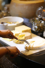 Assorted cheese on a wooden board, cheese tasting concept
