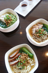 Bowls of pork noodle soup on the table