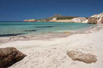 Fototapeta na wymiar Turquoise waters of Firiplaka beach at Milos island in Greece