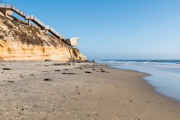 A view of Solana Beach, California, facing south toward Del Mar, with beach access steps and lifeguard station.