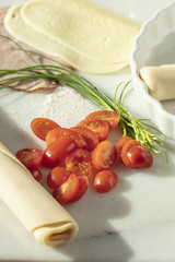 Ham and Cheese tart with tomatoes, chives and spices