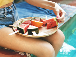Caucasian woman eating watermelon in summertime
