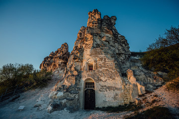 The Icon of the Virgin Mary of Sicilia cave-temple in downs against evening blue sky background....