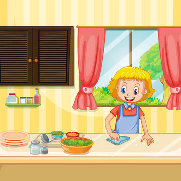 Mother Cleaning and Preparing Food in Kitchen