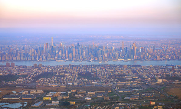 Fototapeta Aerial view of the Manhattan skyline in New York City seen from an airplane window at sunset