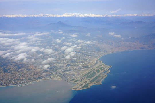 Aerial view of the Nice area, the Baie des Anges and the French Riviera on the Mediterranean Sea with the Nice Cote d'Azur Airport (NCE) in the foreground
