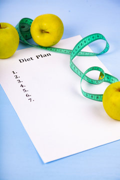 Apples, diet plan,dumbbells and measuring tape