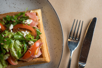 Homemade Belgian Waffle with salad Iceberg, tomatoes and ham