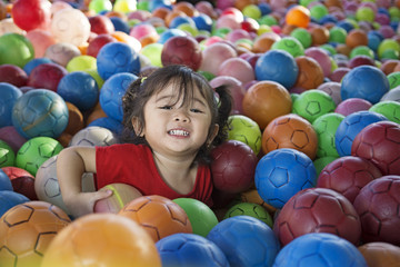 Fototapeta na wymiar Little Girl With Balls