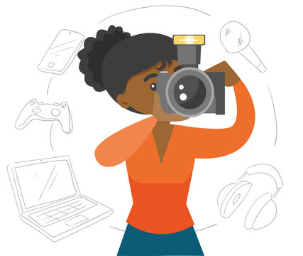 Black woman making a photo with modern camera. Different gadgets: laptop, phone, keypad, headset and microphone located around. Vector cartoon illustration isolated on white background.