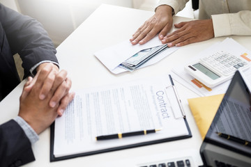 Corrupted businessman, or politician bribe in the form of hundred dollar bills. among high-ranking officials