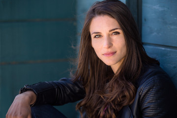 Cool fashionable american woman in leather jacket looking strong, confident, and tough