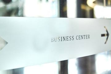 Arrow Sign on glass door to the business center