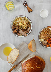 Set healthy porridge with stewed vegetables and turkey on white wooden table, top view. Healthy dinner table, healthy food concept